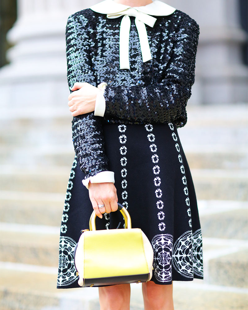 woman in black and white dress at Best Street Style Looks from New york Fashion Week
