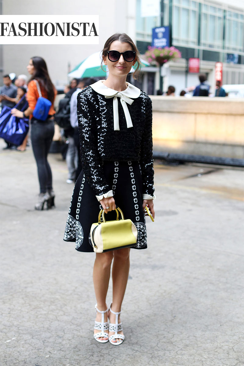 woman in black and white dress and yellow bag for new york fashion week 