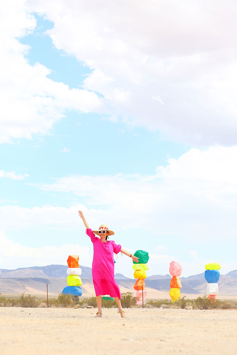 Top fashion blogger Kelly Golightly wears MDS Stripes pink garden dress to Seven Magic Mountains near Las Vegas, Nevada.