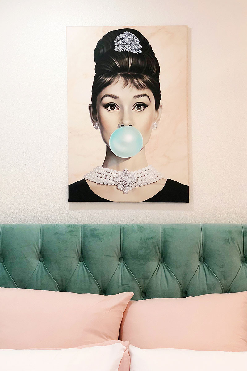 Audrey Hepburn Bubblegum Art Print on top of a headboard 
