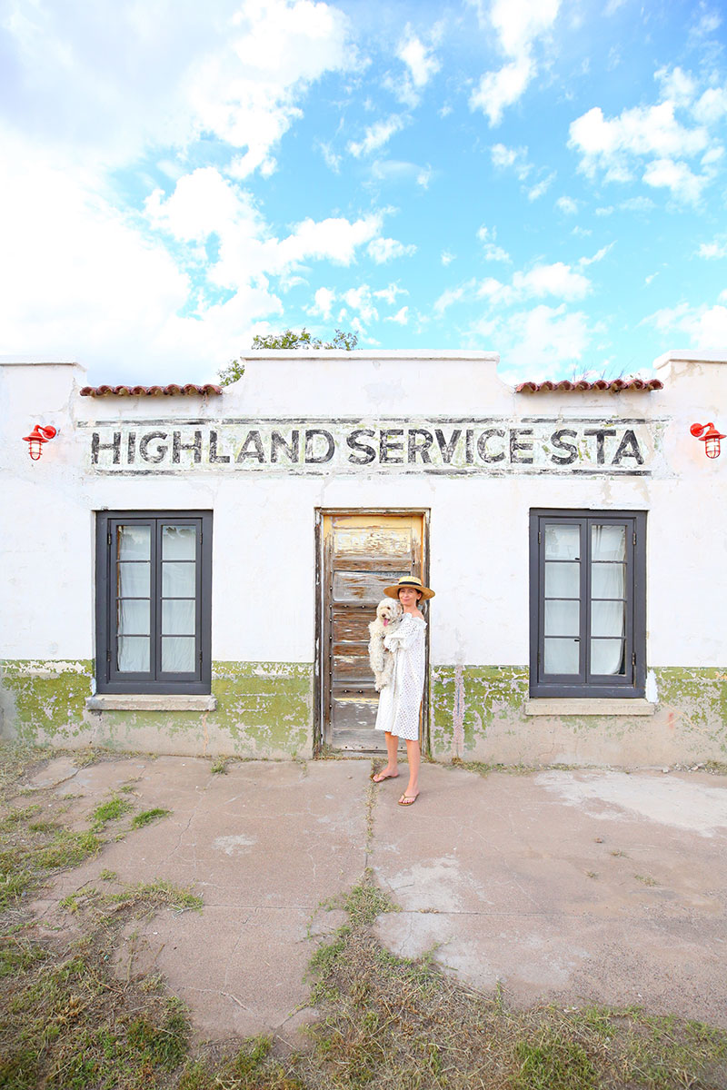 woman carrying her dog and sharing where to Stay in Marfa