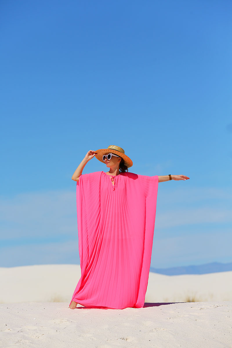 woman wearing hat, pink caftans, and sunglasses 