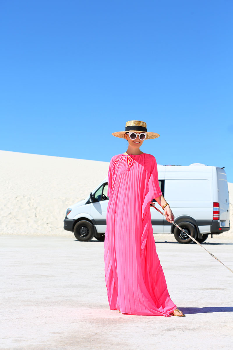 woman in pink caftan and walking her do in White Sands National Park