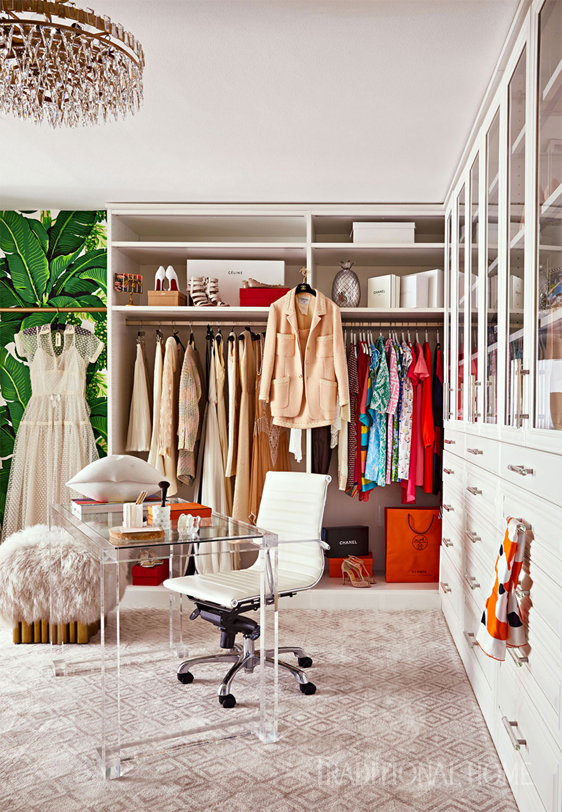 closet and an office in one room with clothes, glass table, and office chair for traditional home magazine