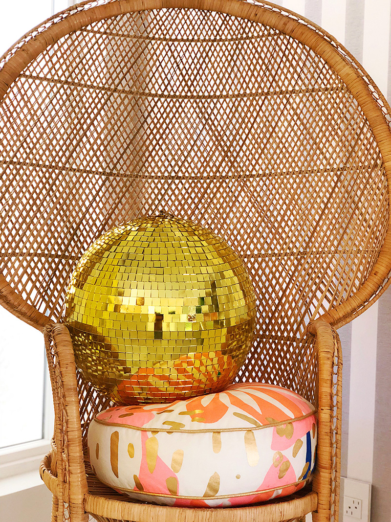 rattan chair with yellow disco ball as Christmas Decor in Palm Springs