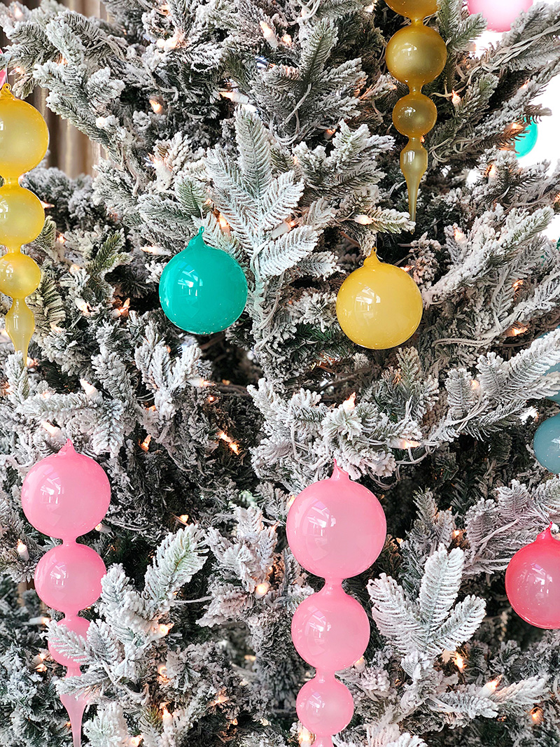 round pastel decorations on a christmas tree 