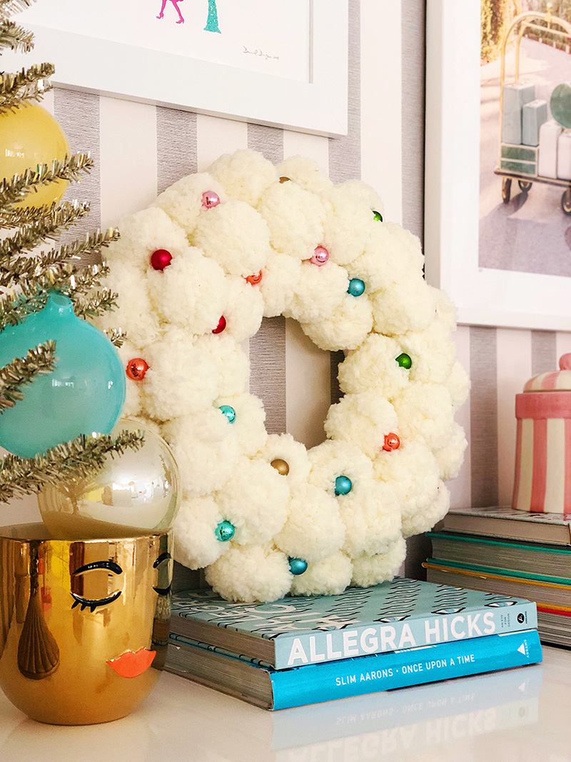 white wreath, small christmas tree, and books 