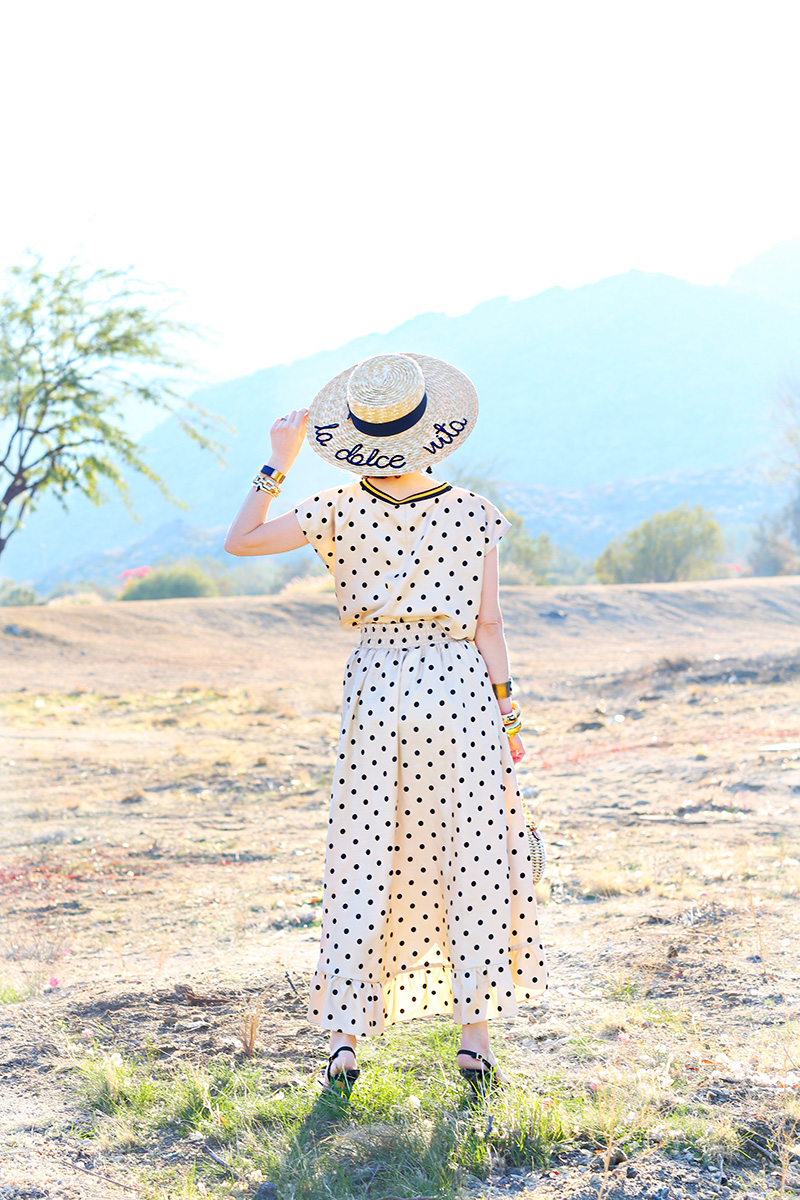 back of a woman wearing a polka dot dress