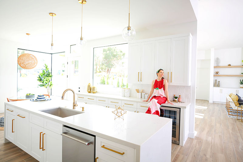 Woman sitting at a kitchen countertop in Vacation Homes Palm Springs 