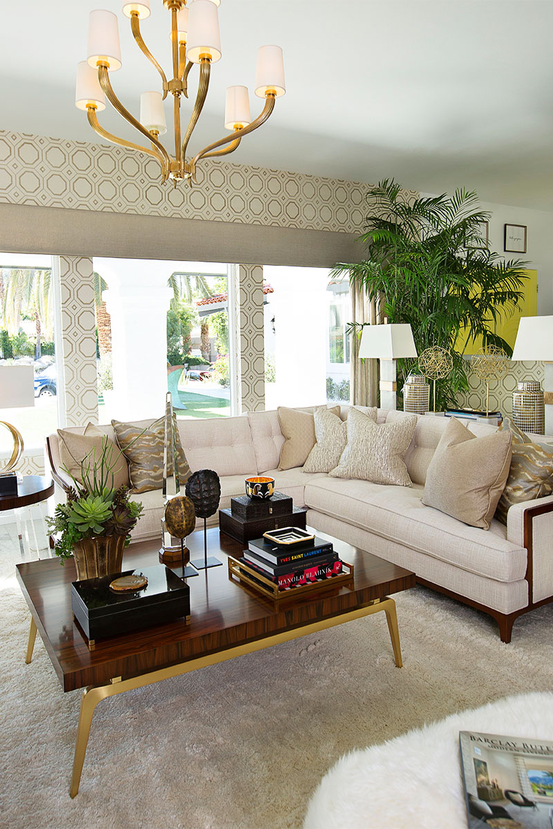 formal living room with l-type couch, wood coffee table, and chandelier 