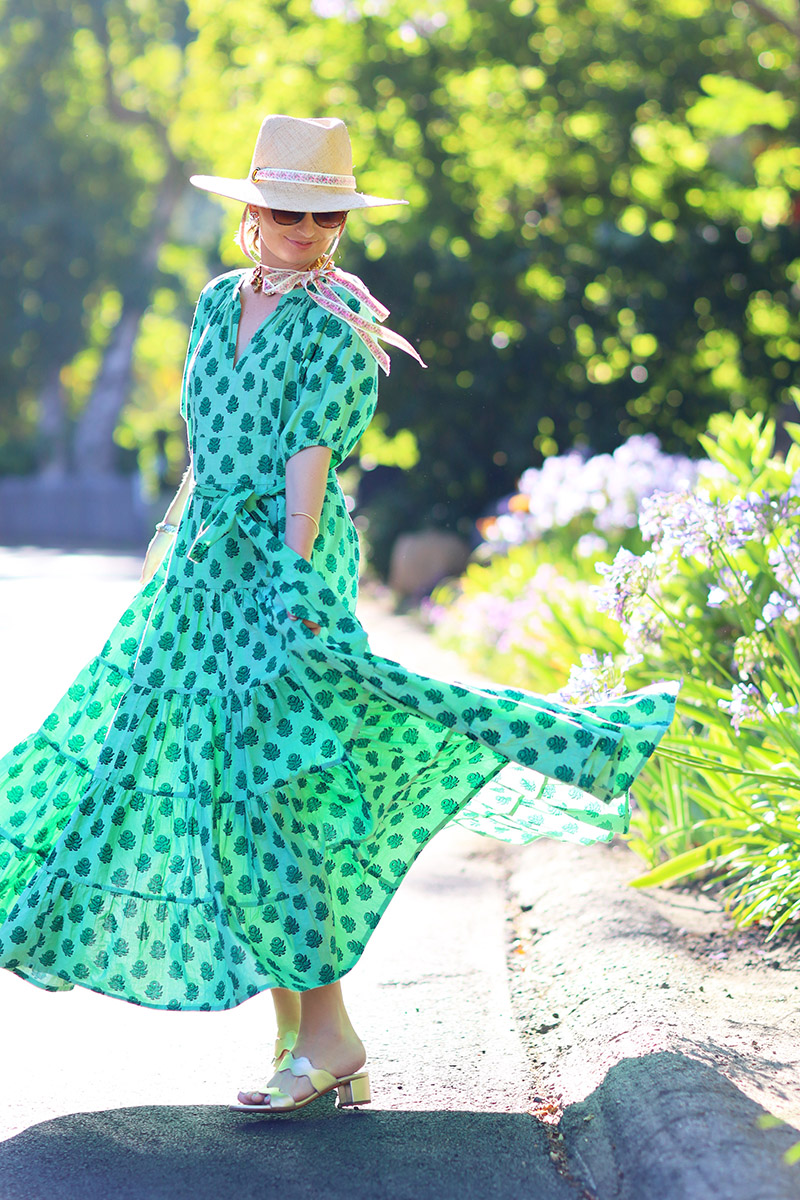 Fashion blogger Kelly Golightly wears a green breezy summer dress while twirling in Bel-Air.